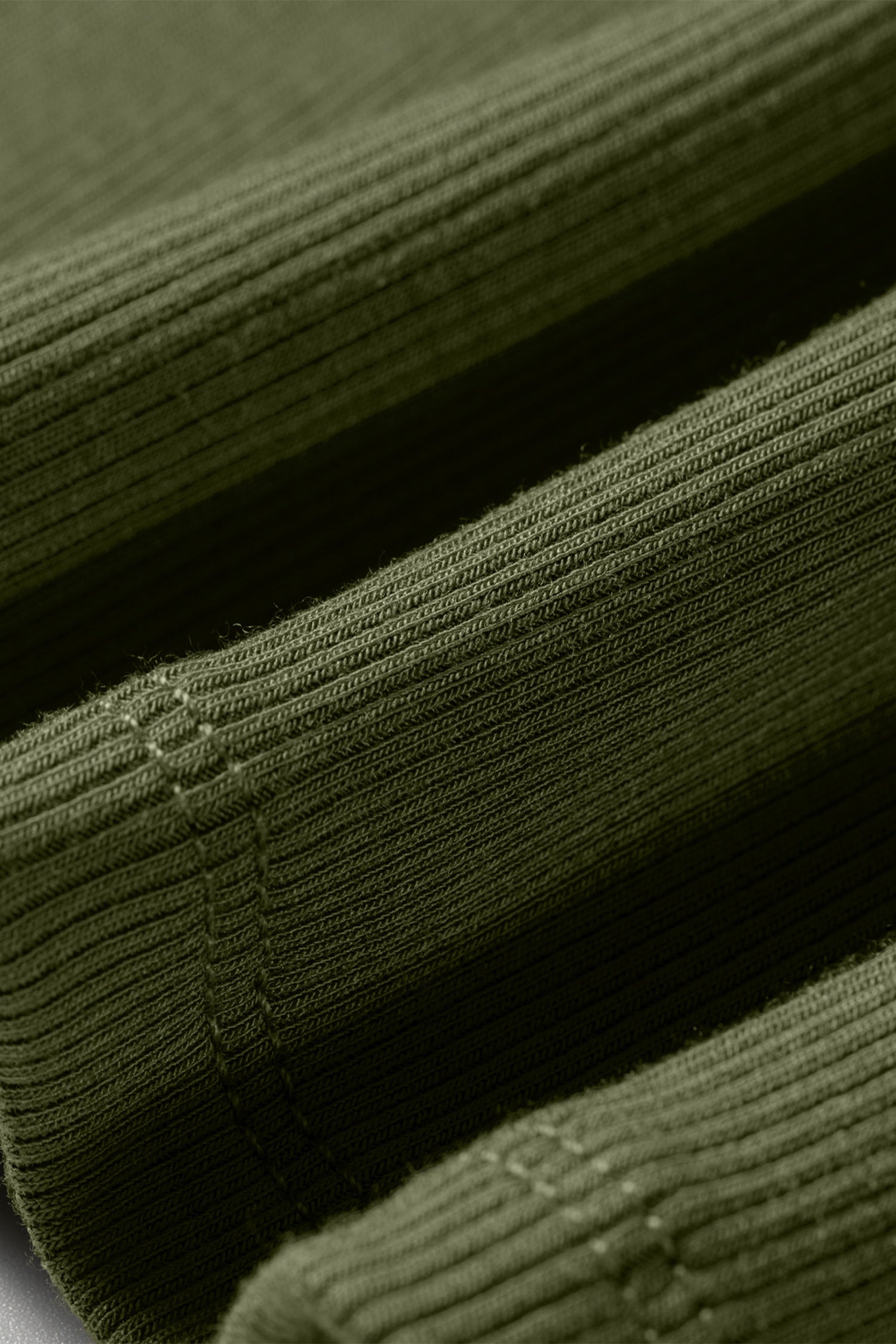 Close-up of green ribbed fabric with a textured pattern