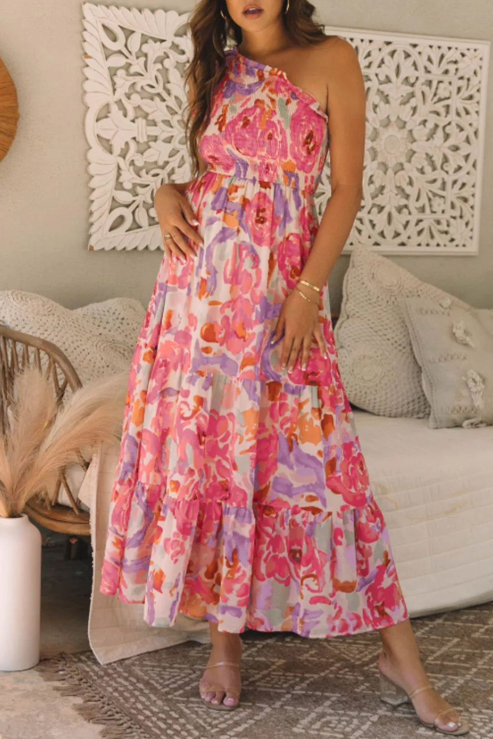 Woman wearing a colorful floral dress in a living room setting