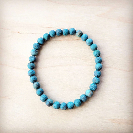 Turquoise beaded bracelet on a light wooden surface