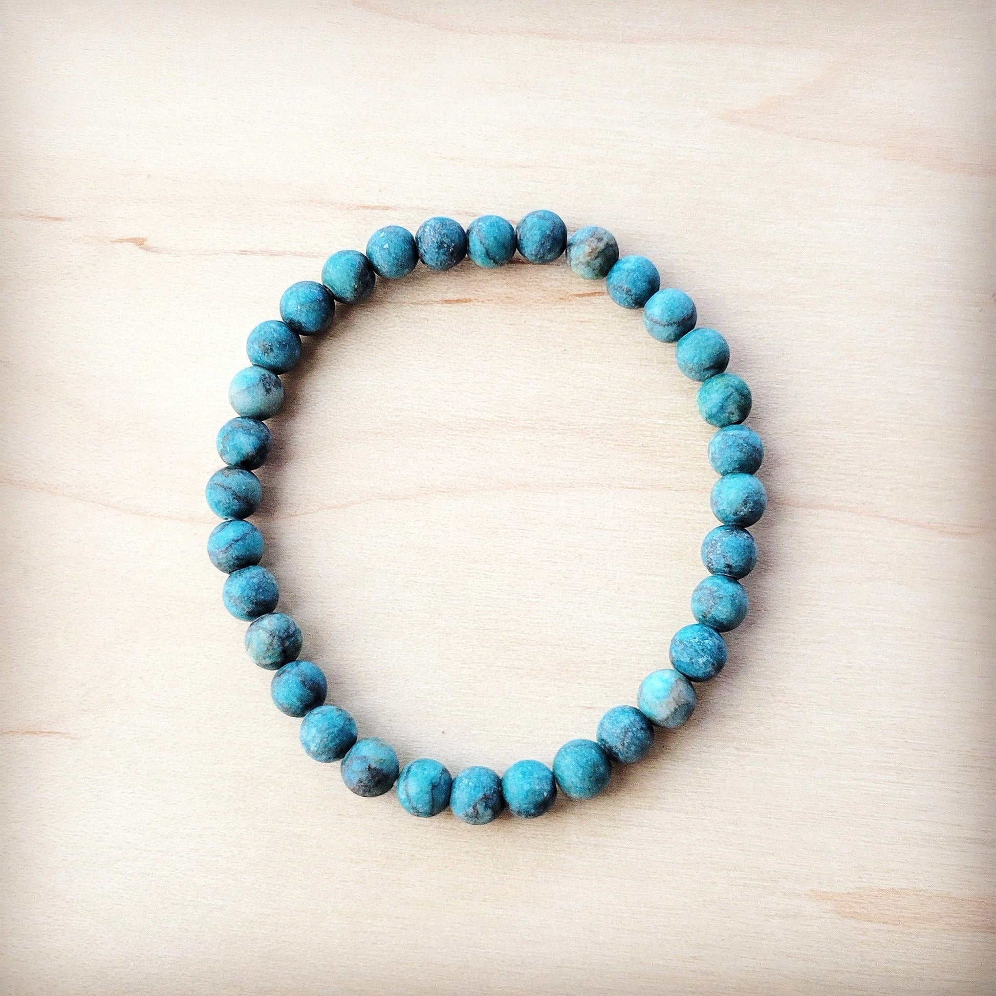 Turquoise beaded bracelet on a light wooden surface