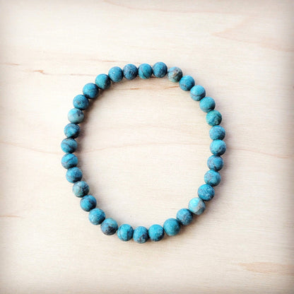 Turquoise beaded bracelet on a light wooden surface