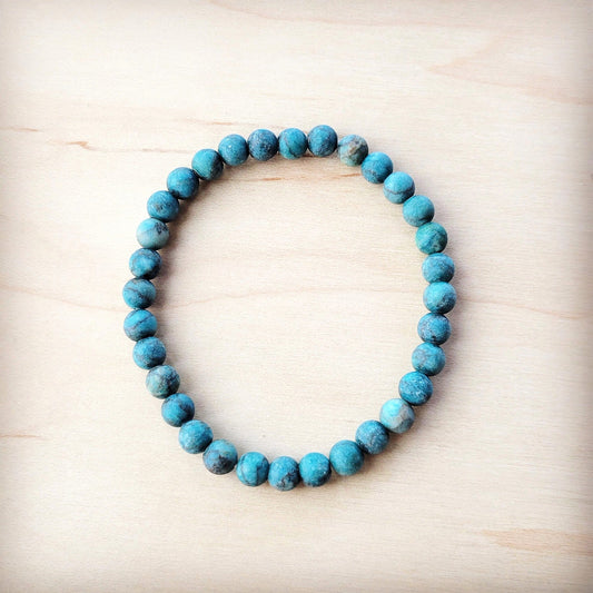 Turquoise beaded bracelet on a light wooden surface