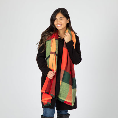 Woman wearing a colorful plaid scarf on a white background