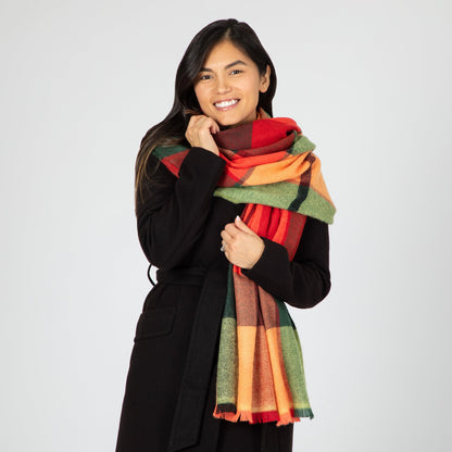 Woman wearing a colorful scarf with a plain background
