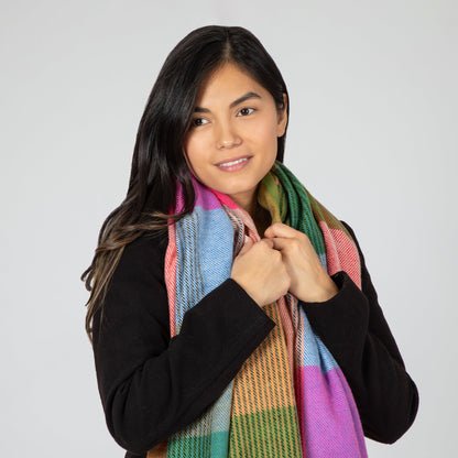 Woman wearing a colorful scarf on a plain background