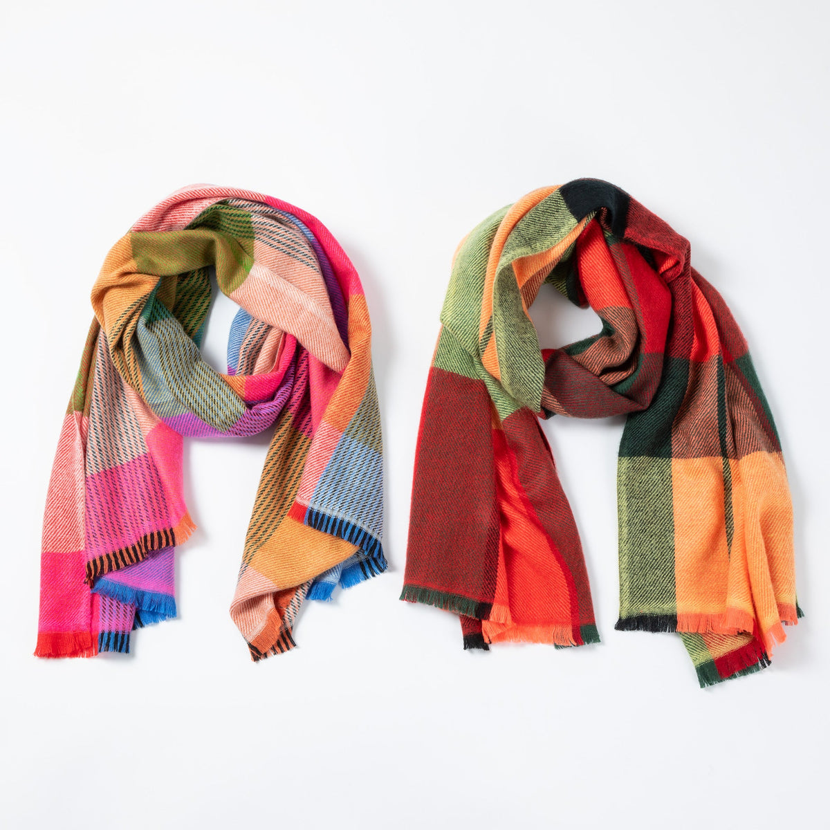 Two colorful plaid scarves on a white background
