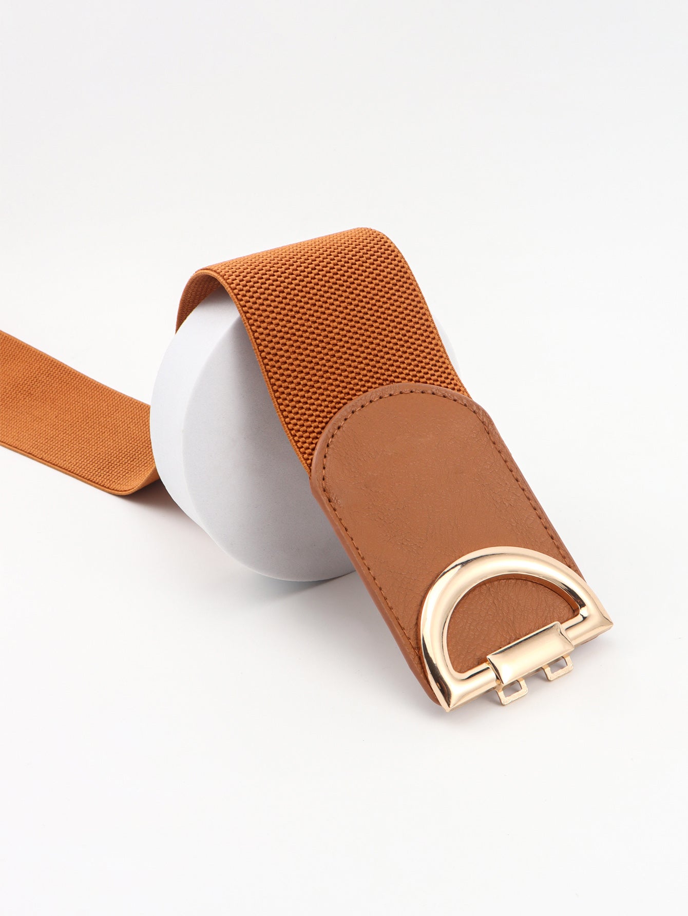 Brown belt with a gold buckle on a white background