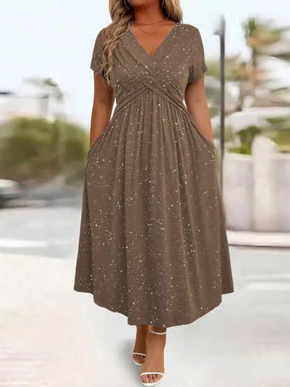 Woman wearing a brown dress with a blurred outdoor background