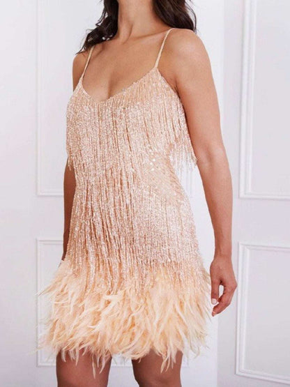 Beige fringe dress worn by a person against a white background