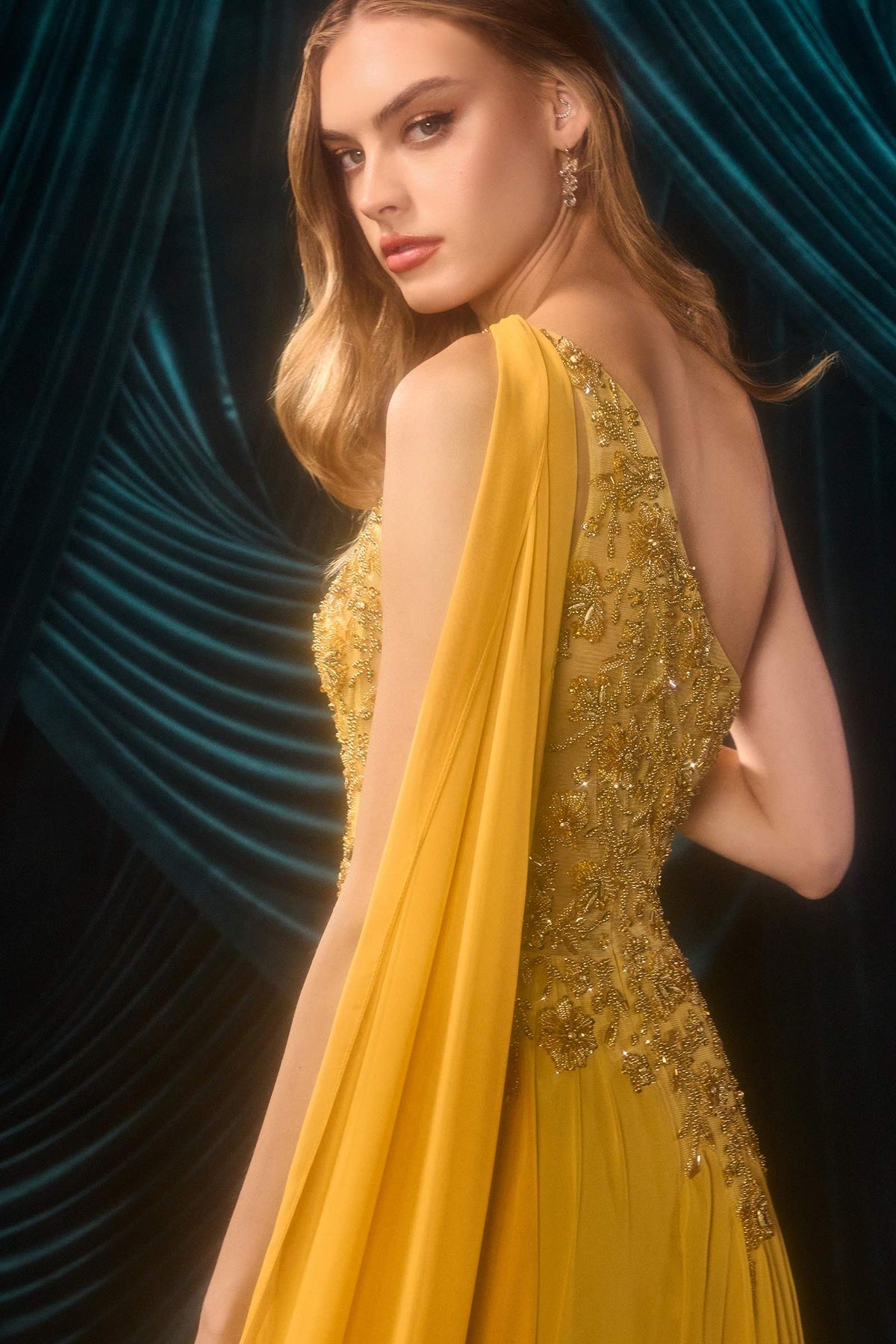 Close-up of Andrea & Leo A1495 marigold gown showing beaded back detailing and chiffon shoulder cape.