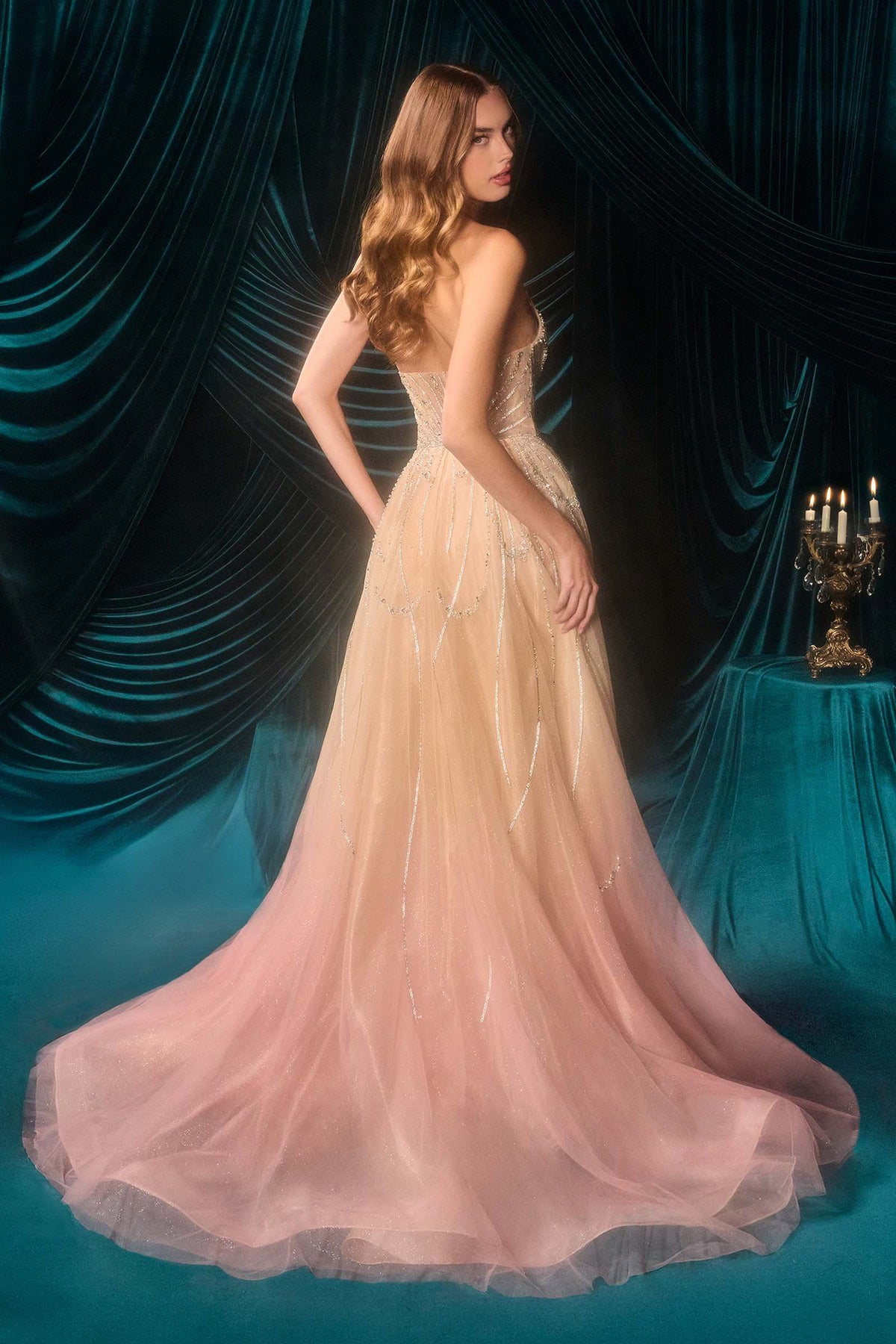 Champagne/blush, back: Rear three-quarter view of Andrea & Leo A1508 champagne/blush gown showing the flowing tulle overskirt and train.
