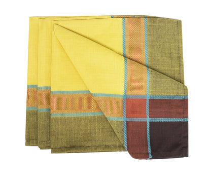 A folded woven textile, likely a scarf, handkerchief, or pocket square, featuring a yellow center with a plaid border in olive green, orange, light blue, brown, and dark brown.