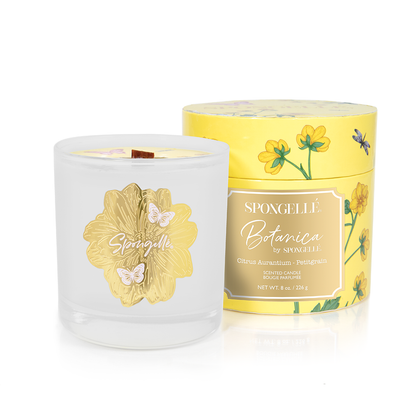 Spongellé Botanica Petitgrain candle in a clear glass jar with a gold floral design and yellow floral box packaging.