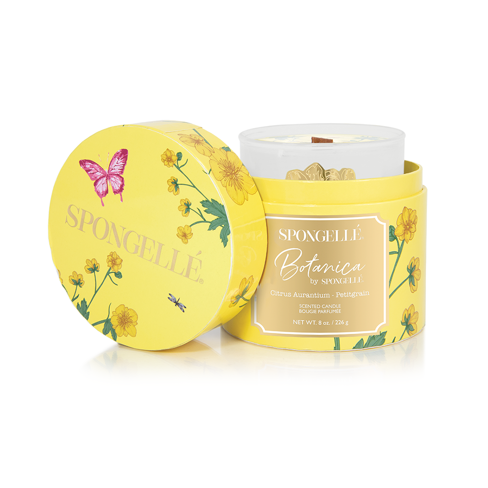Yellow Petitgrain Botanica candle in a floral-patterned container with a butterfly design, featuring a white wax interior.