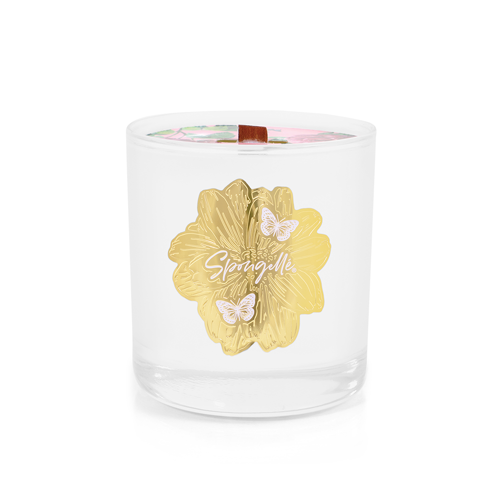 Rose botanica candle in a clear glass container featuring a gold floral design and colorful floral lid.