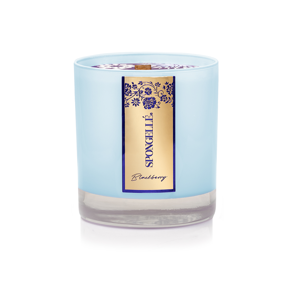 Blue glass candle with a wooden wick, labeled "Blackberry" in gold and purple accents.
