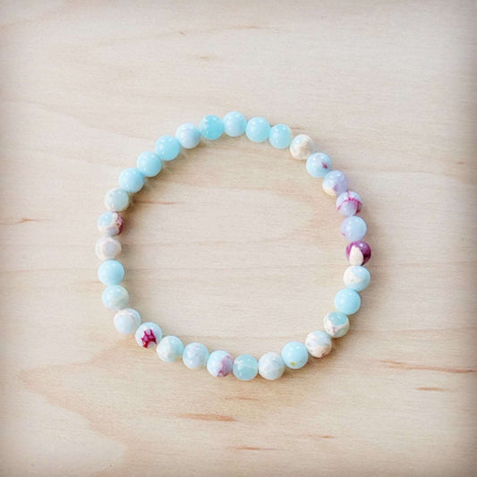 Beaded bracelet with multicolored beads on a wooden surface