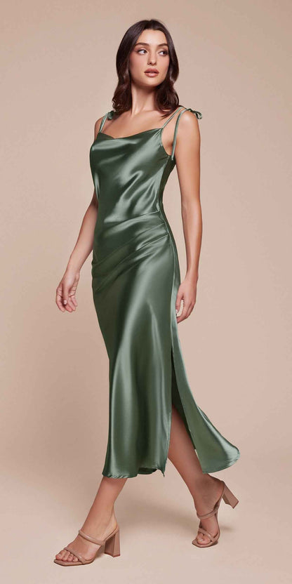 Woman wearing a green satin dress on a beige background
