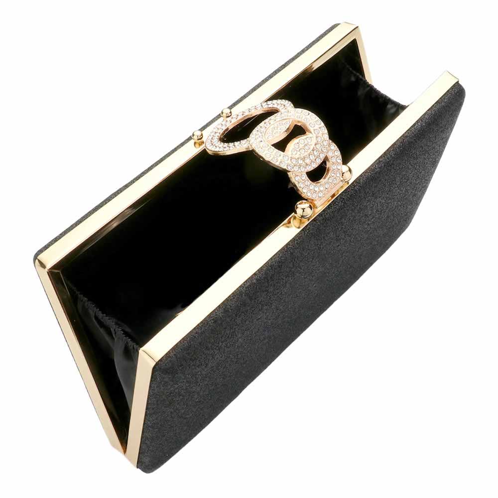 Black clutch with gold accents and a decorative clasp on a white background