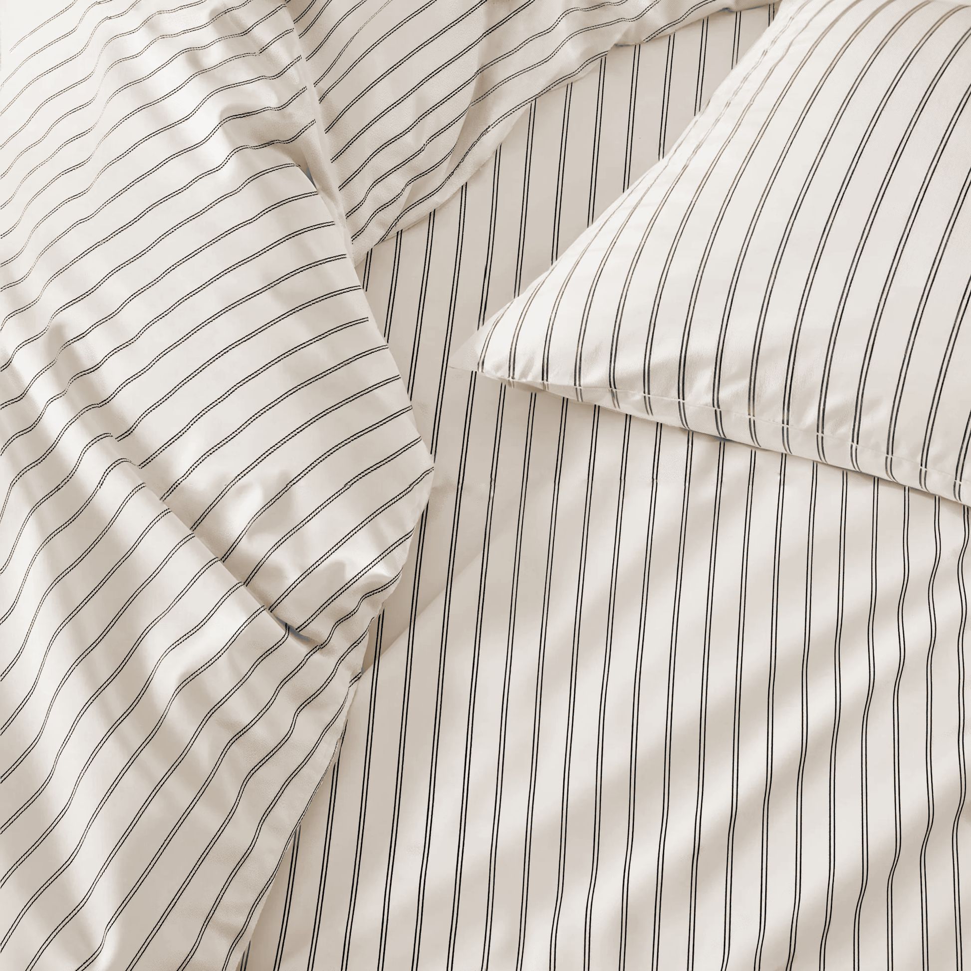 Close-up of striped bedding with a pillow corner.