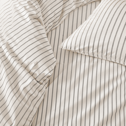 Close-up of striped bedding with a pillow corner.