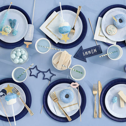 Blue theme party table featuring props for new baby boy.