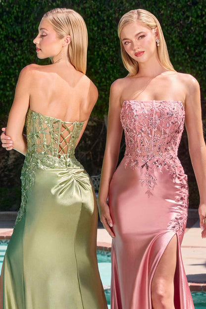 Two women in elegant evening gowns by a poolside.