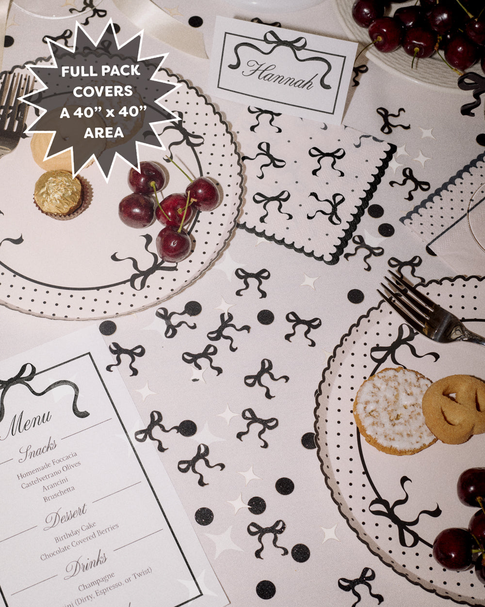 Decorative table setting with black and white patterns on a white tablecloth.