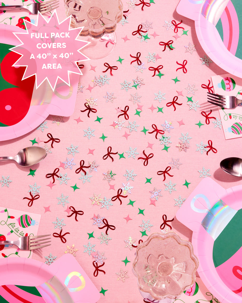 Pink tablecloth with festive patterns and cutlery on a pink background