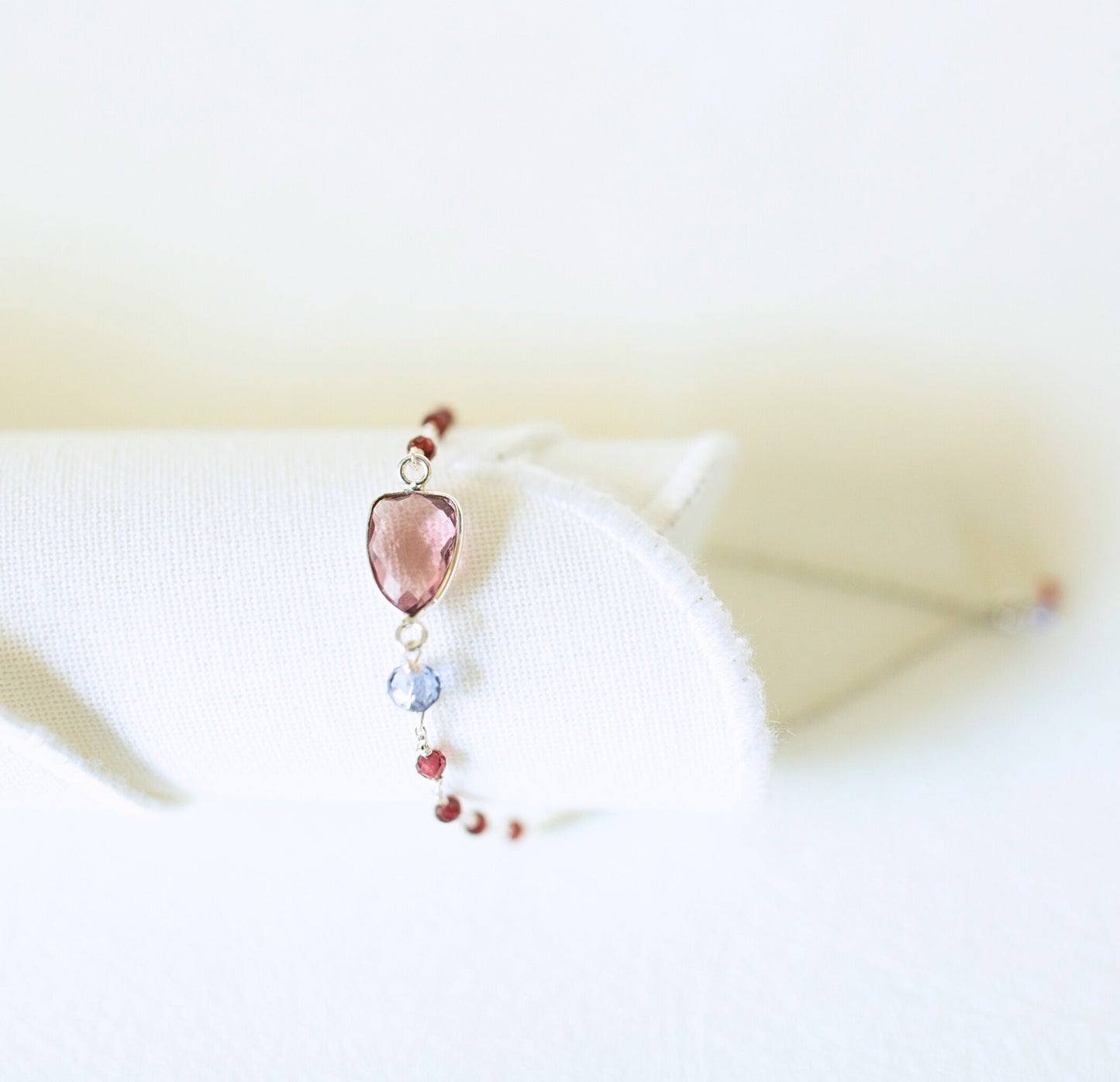 Necklace with a heart-shaped pink pendant on a white background
