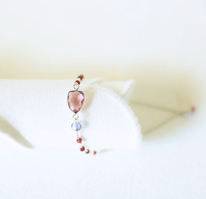 Necklace with a heart-shaped pink pendant on a white background