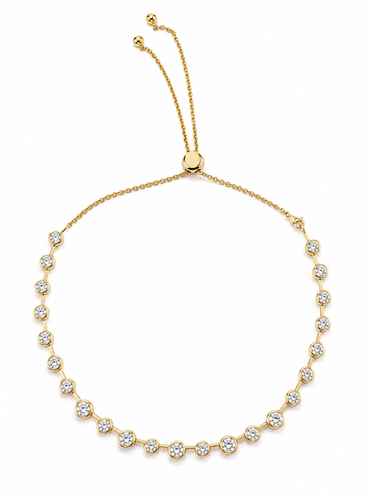 Gold Lora necklace with round bezel-set cubic zirconia stones and an adjustable slider chain on a white background.