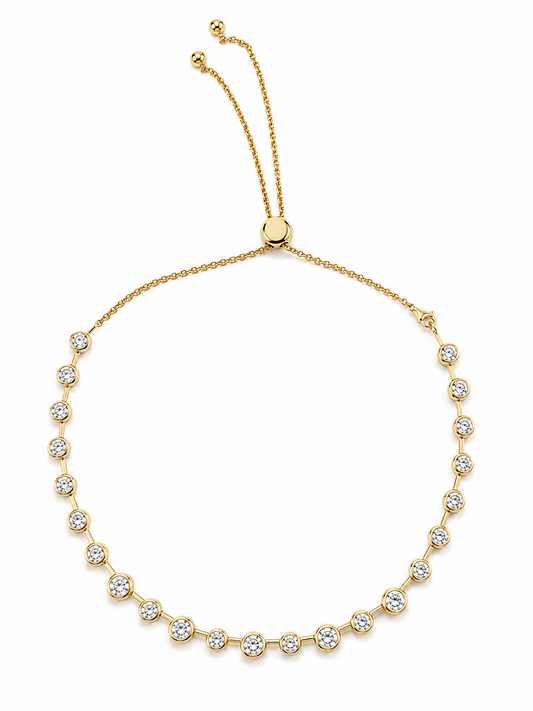 Gold Lora necklace with round bezel-set cubic zirconia stones and an adjustable slider chain on a white background.