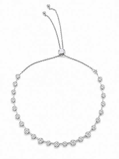 Silver Lora necklace with round bezel-set cubic zirconia stones and an adjustable slider chain on a white background.