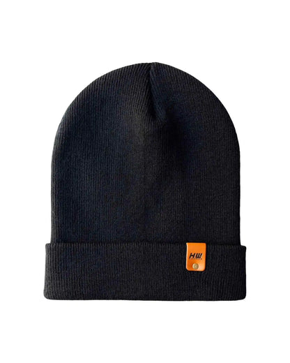A black ribbed knit beanie hat with a folded cuff and a small orange Helly Hansen logo tab on the side, shown against a plain white background.