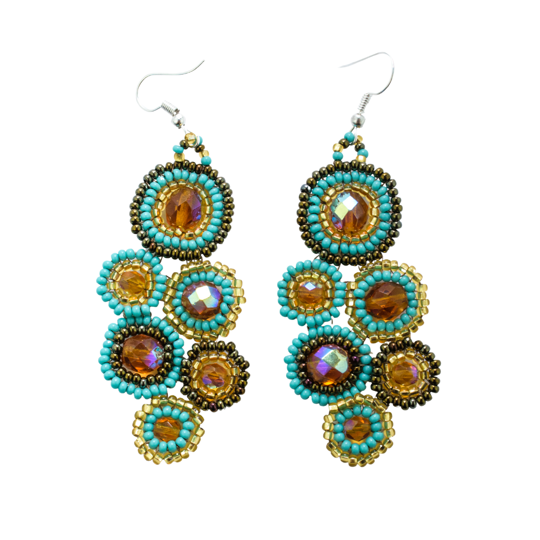 Pair of beaded earrings with turquoise and gold colors on a white background