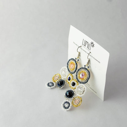 Colorful beaded earrings on a white card with 'Lumily' branding against a light gray background