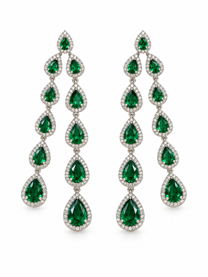 Emerald green drop earrings on a white background