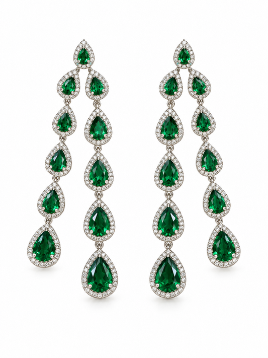 Emerald green drop earrings on a white background