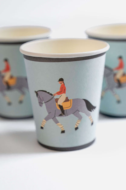 Set of paper cups with equestrian design on a light blue background