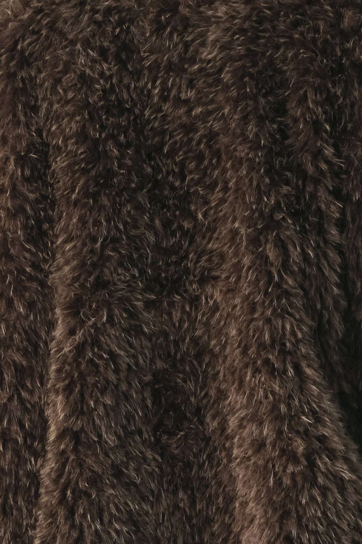 A close-up of dark brown shaggy faux fur fabric texture.