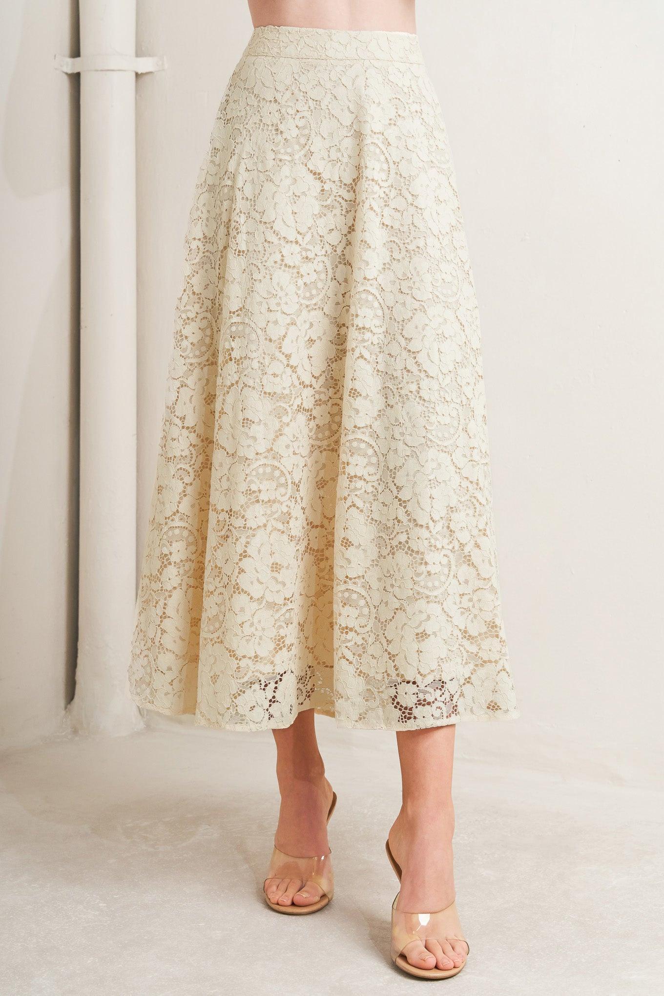 Beige lace skirt worn by a person on a white background