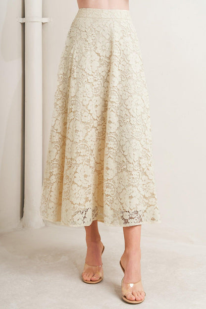 Beige lace skirt worn by a person on a white background