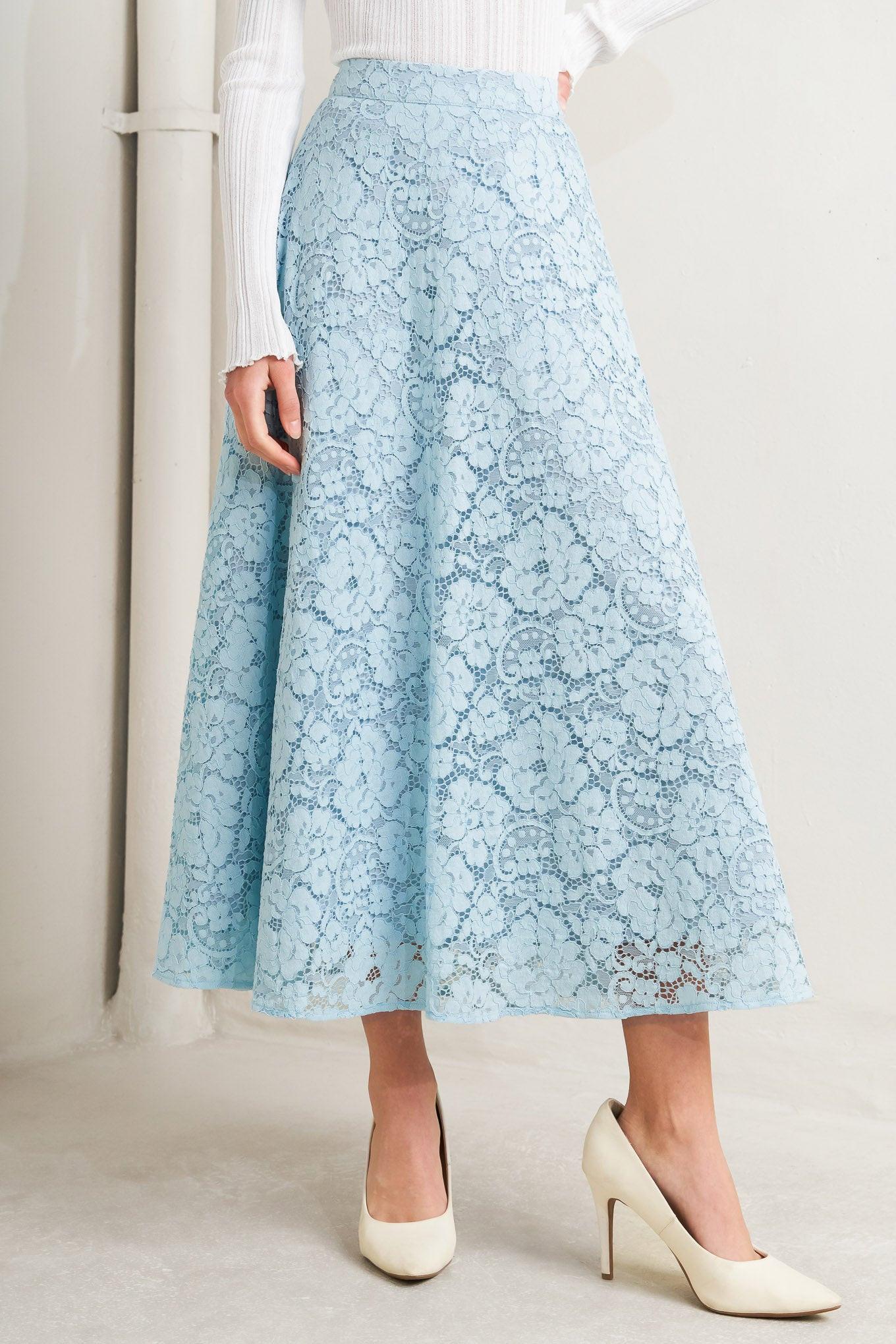 Light blue lace skirt worn by a person on a plain background