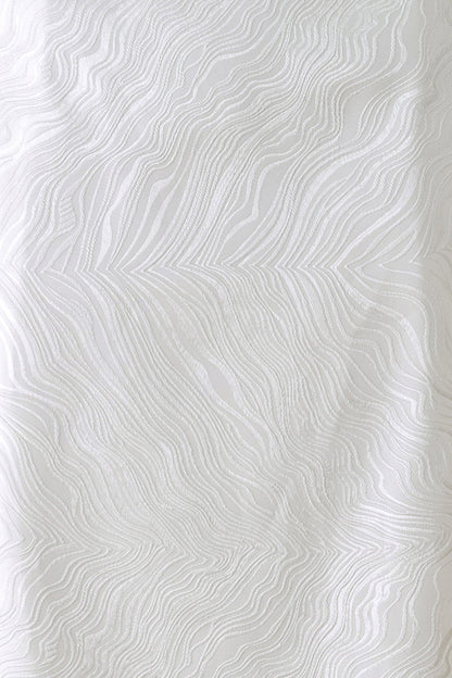 White textured fabric with a raised wavy, topographic pattern.