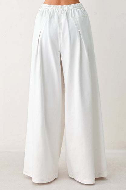 White wide-leg pants on a plain background