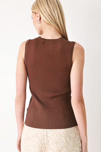 Woman wearing a brown ribbed sleeveless top against a white background