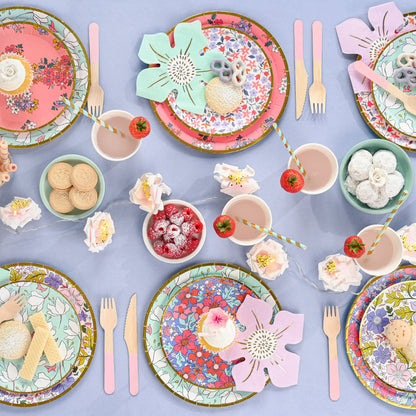 Table setting featuring colorful floral disposable paper plates.