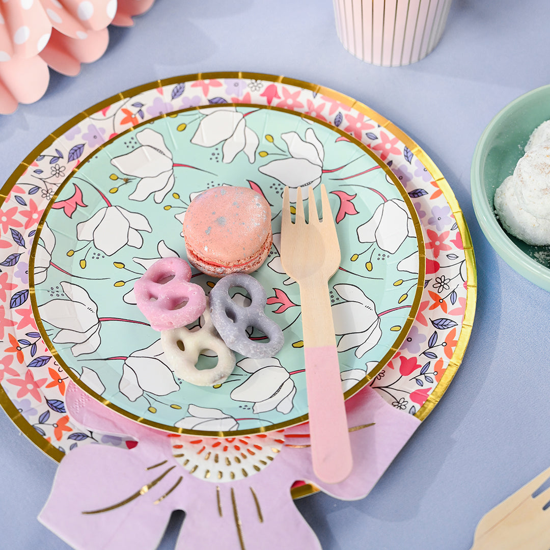 Table setting featuring colorful floral disposable paper plates.