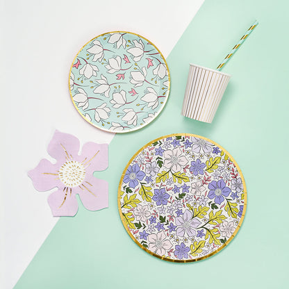 Table setting featuring colorful floral disposable paper plates.